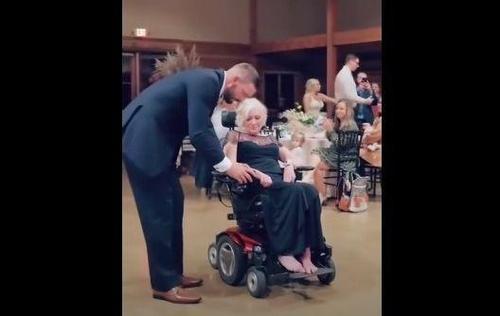 Loving Son Assists Sick Mother To Ballroom Floor And Lifts Her Up For Dance Not To Be Forgotten